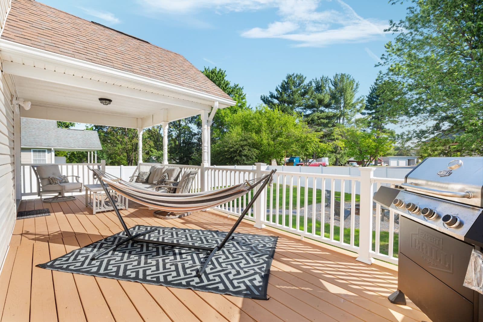 Covered deck with hammock, gas grill and seating at Heart of Luray