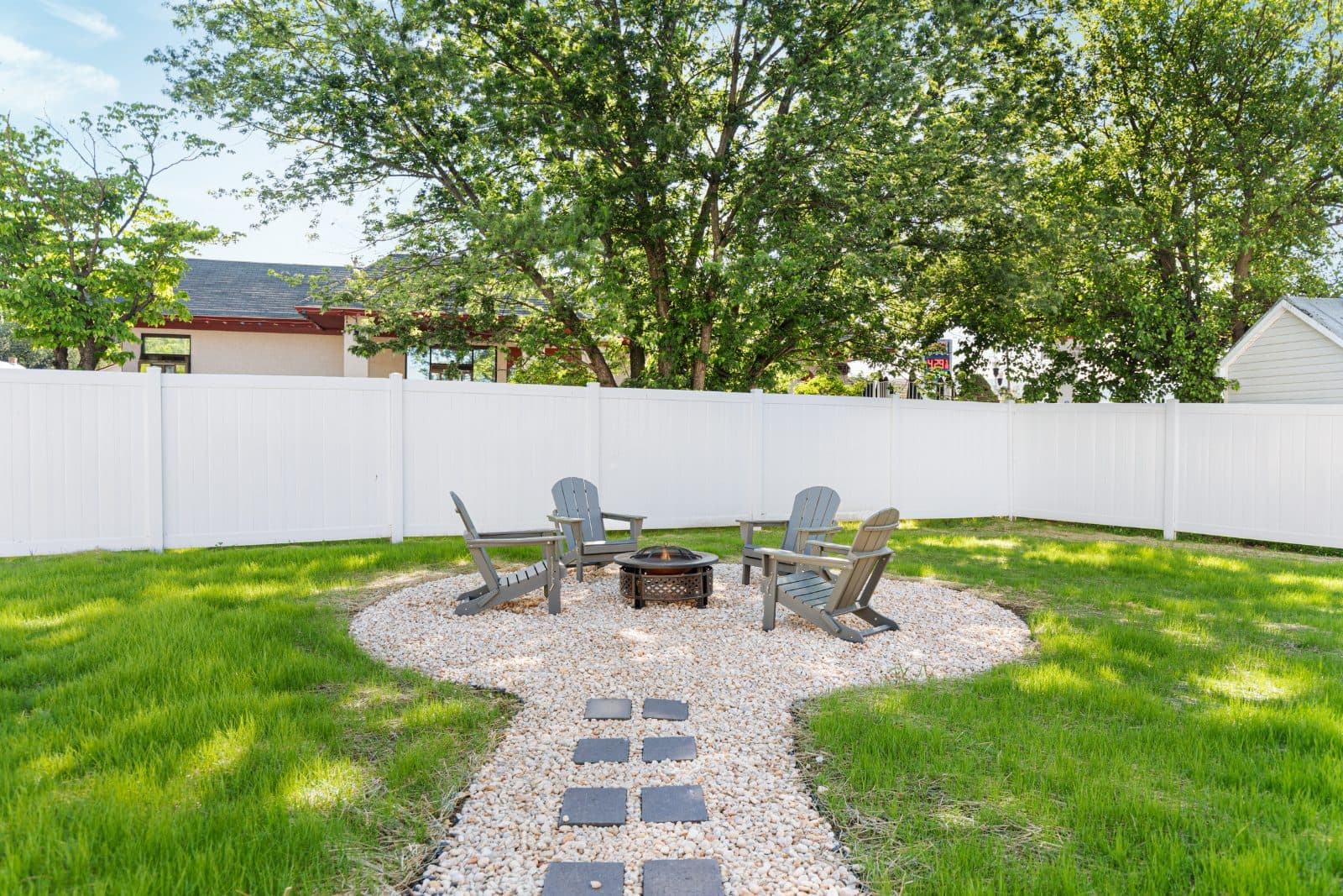 The fenced lawn and tree line at Heart of Luray vacation rental